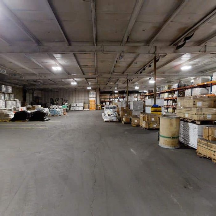 Tile warehouse stocked with boxed porcelain and ceramic tile materials.